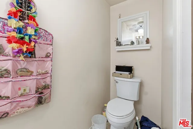 a white toilet sitting next to a small bathroom