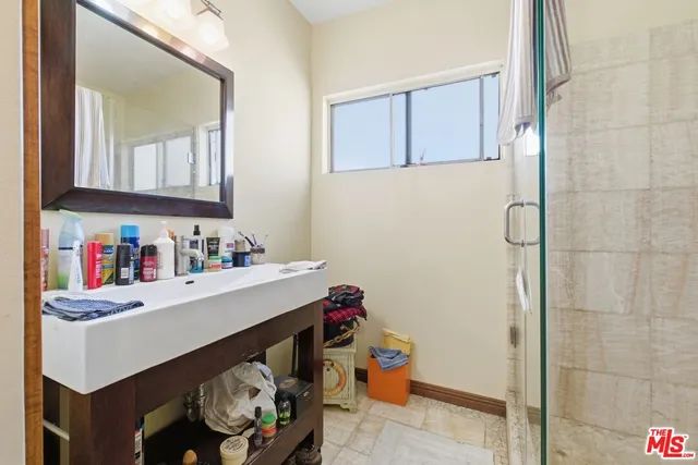 a bathroom with a sink a vanity and a window