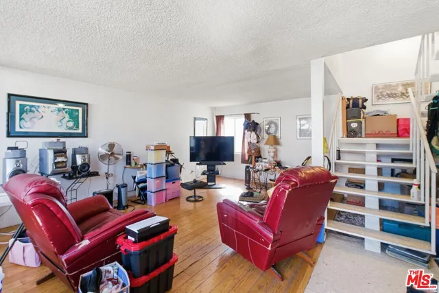 a living room with furniture a red couch and a flat screen tv