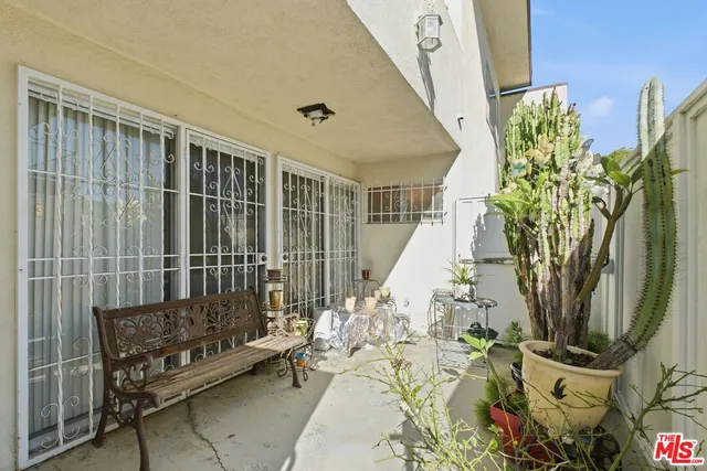a living room with furniture and a gym machine