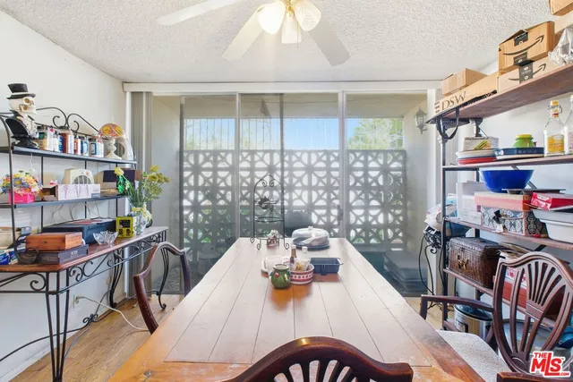 a view of a dining room with furniture a rug and wooden floor