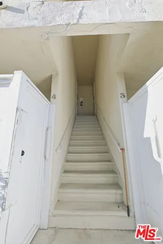 a view of a house with wooden fence