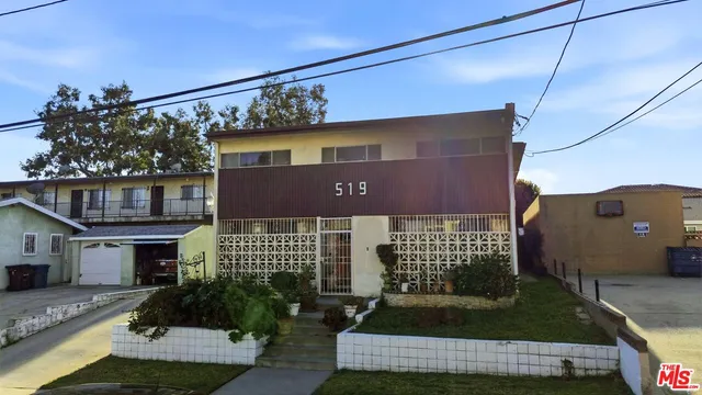 an aerial view of a house with outdoor seating