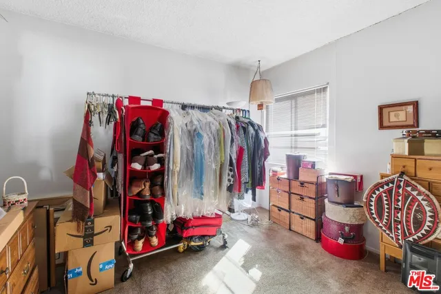 a view of walk in closet with clothes
