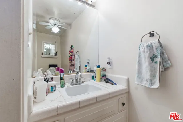 a bathroom with a sink vanity and mirror