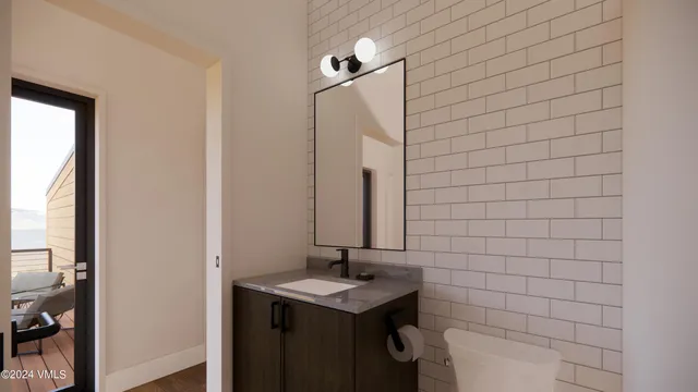 a bathroom with a sink a toilet and mirror