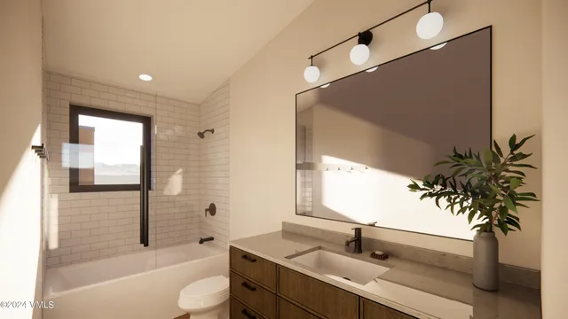 a bathroom with a granite countertop sink a large mirror a bathtub and shower