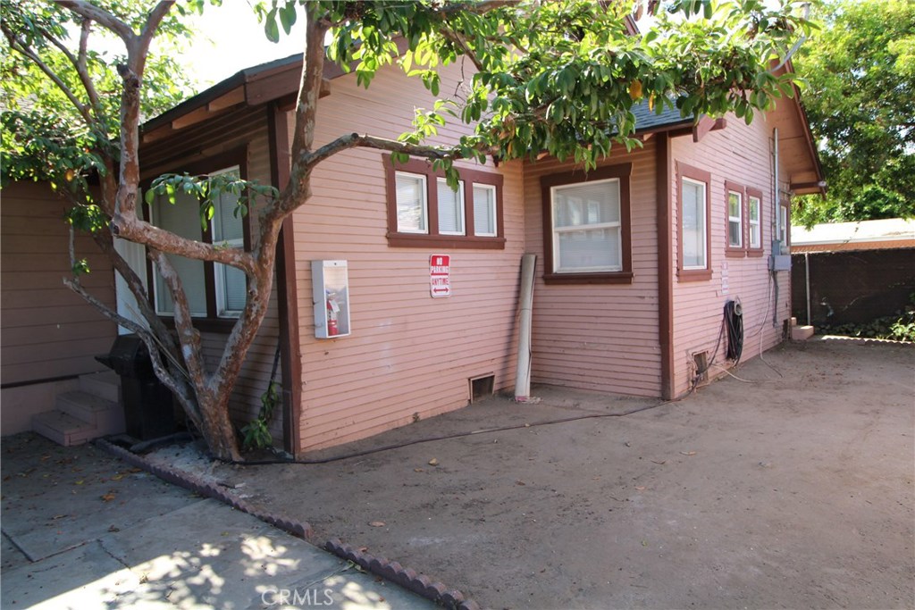 7024 Middleton Street, Unit B Huntington Park, CA 90255 - Photo 4 of 8 a view of a house with a small yard and large tree