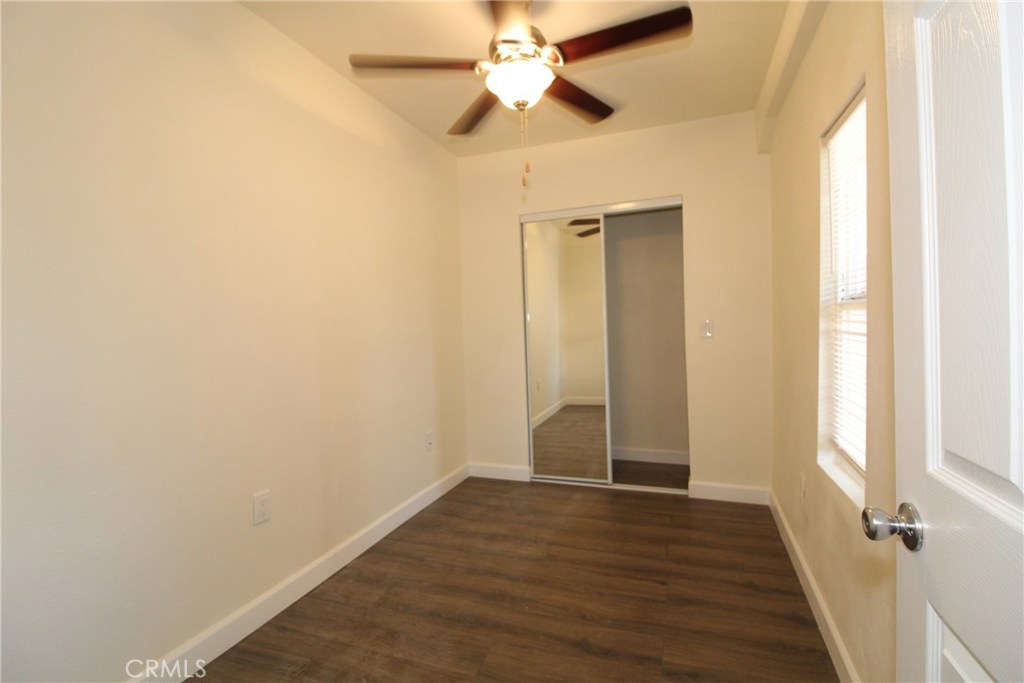 7024 Middleton Street, Unit B Huntington Park, CA 90255 - Photo 7 of 8 an empty room with wooden floor closet and windows