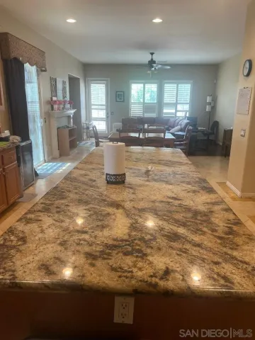 a view of a kitchen with furniture and a refrigerator