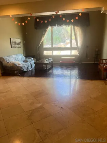 a bedroom with double vanity and a large window