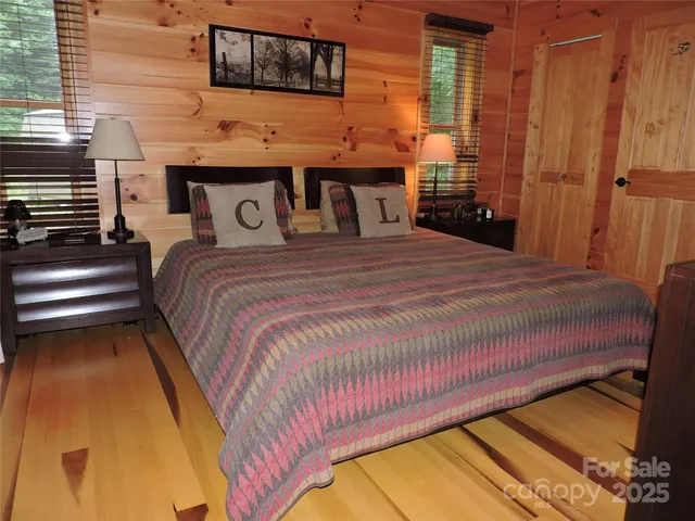 a bed sitting in a bedroom next to a window