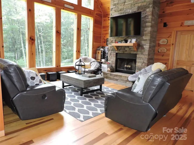 a living room with furniture fireplace and flat screen tv