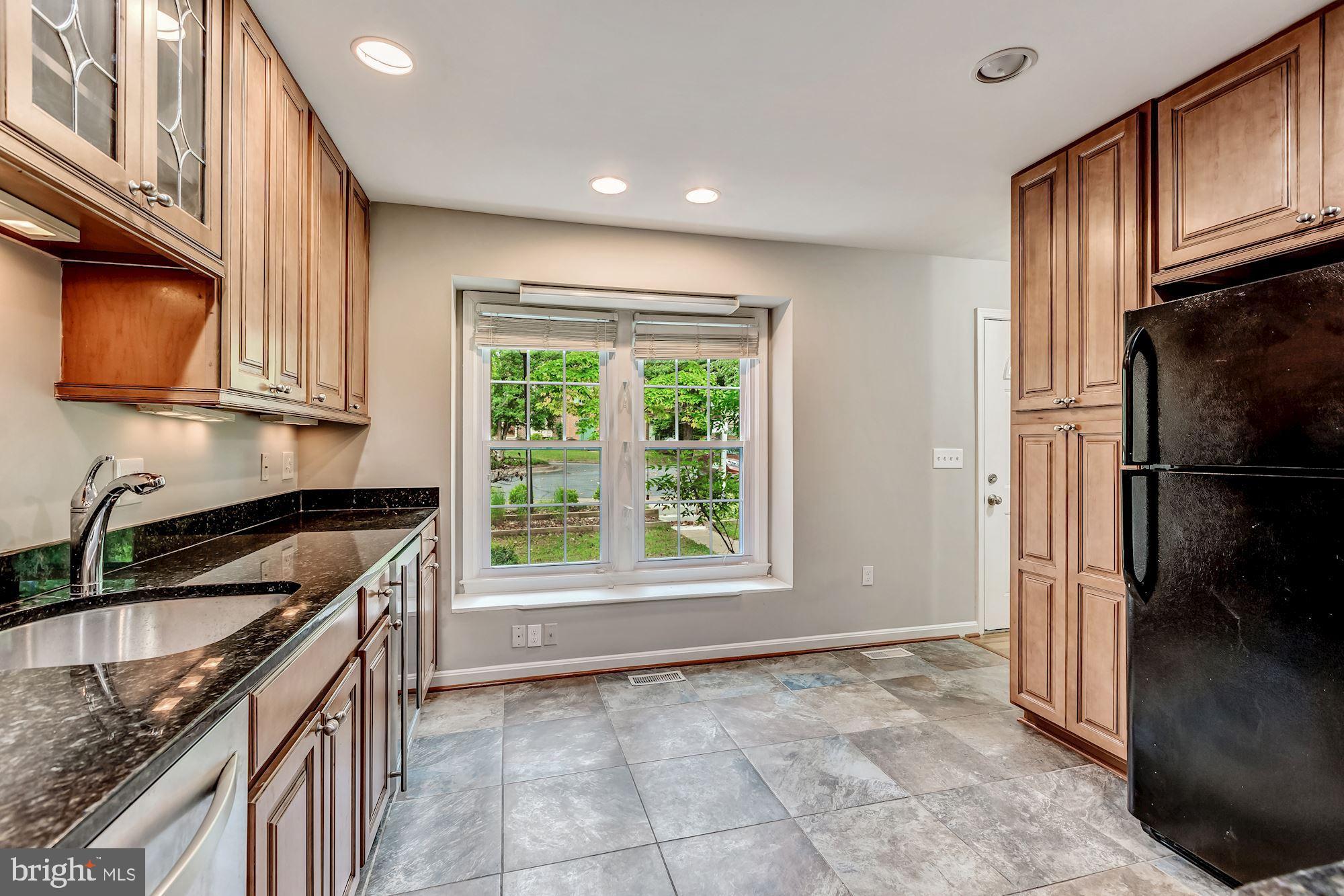 Recessed lighting and maple cabinets in kitchen