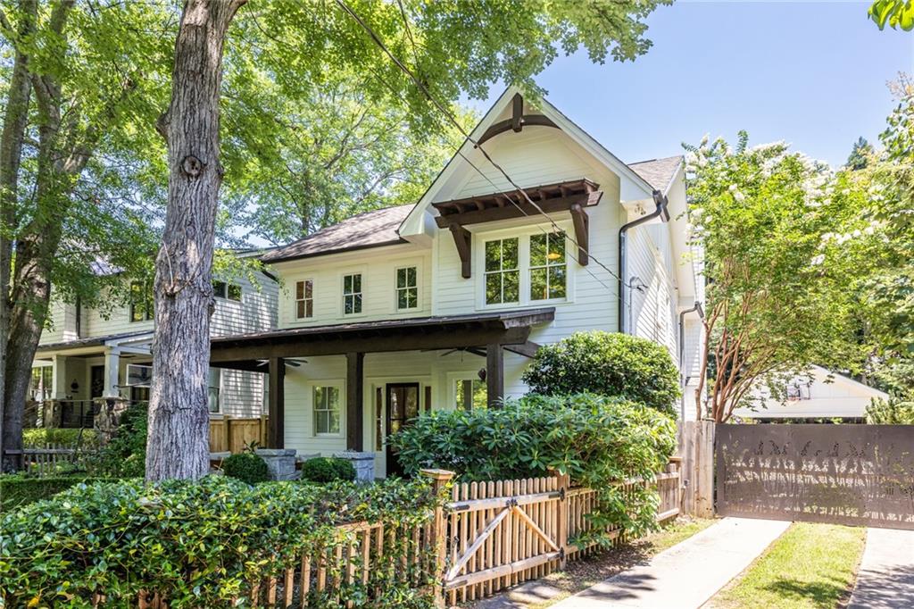 538 Ansley Street Decatur, GA 30030 - Photo 59 of 73 a view of a white house with large windows and a small yard