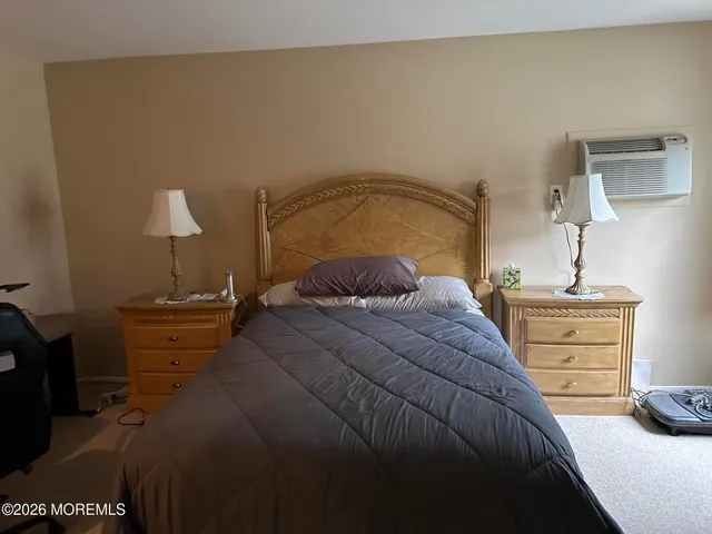 a bedroom with a bed and a lamp
