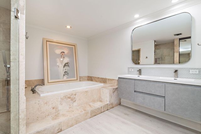 a bathroom with a sink mirror and vanity