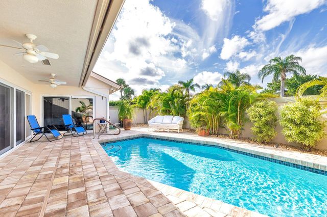 a view of a house with swimming pool and sitting area