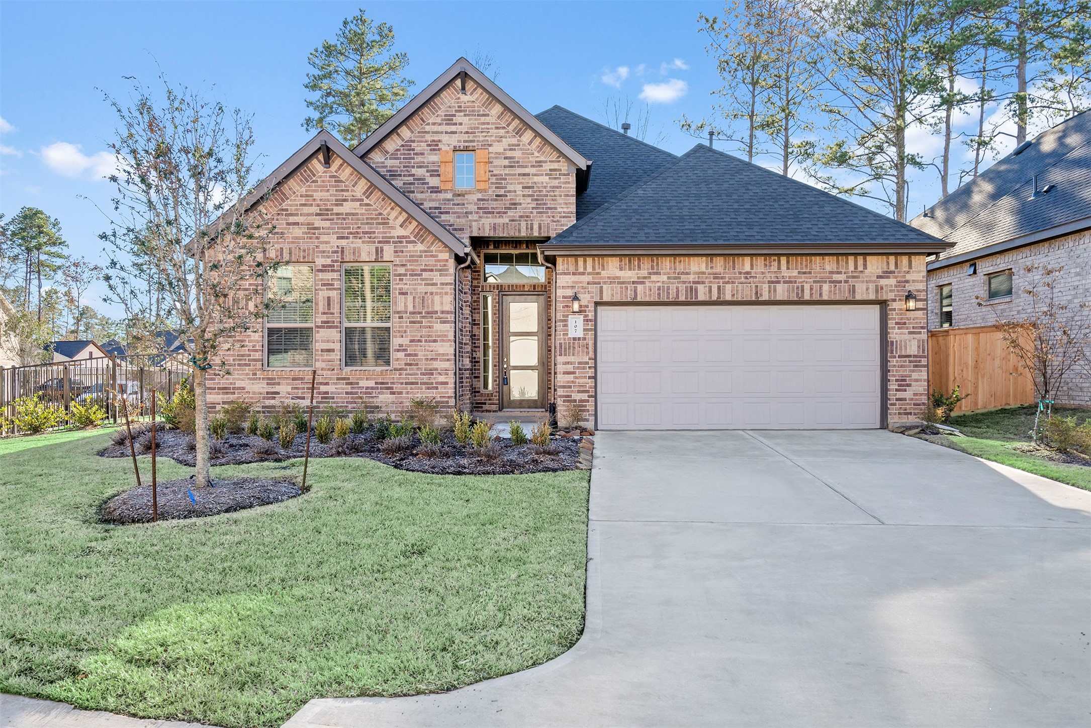 107 Yellow Perch Way Conroe, TX 77318 - Photo 2 of 36 a front view of a house with garden