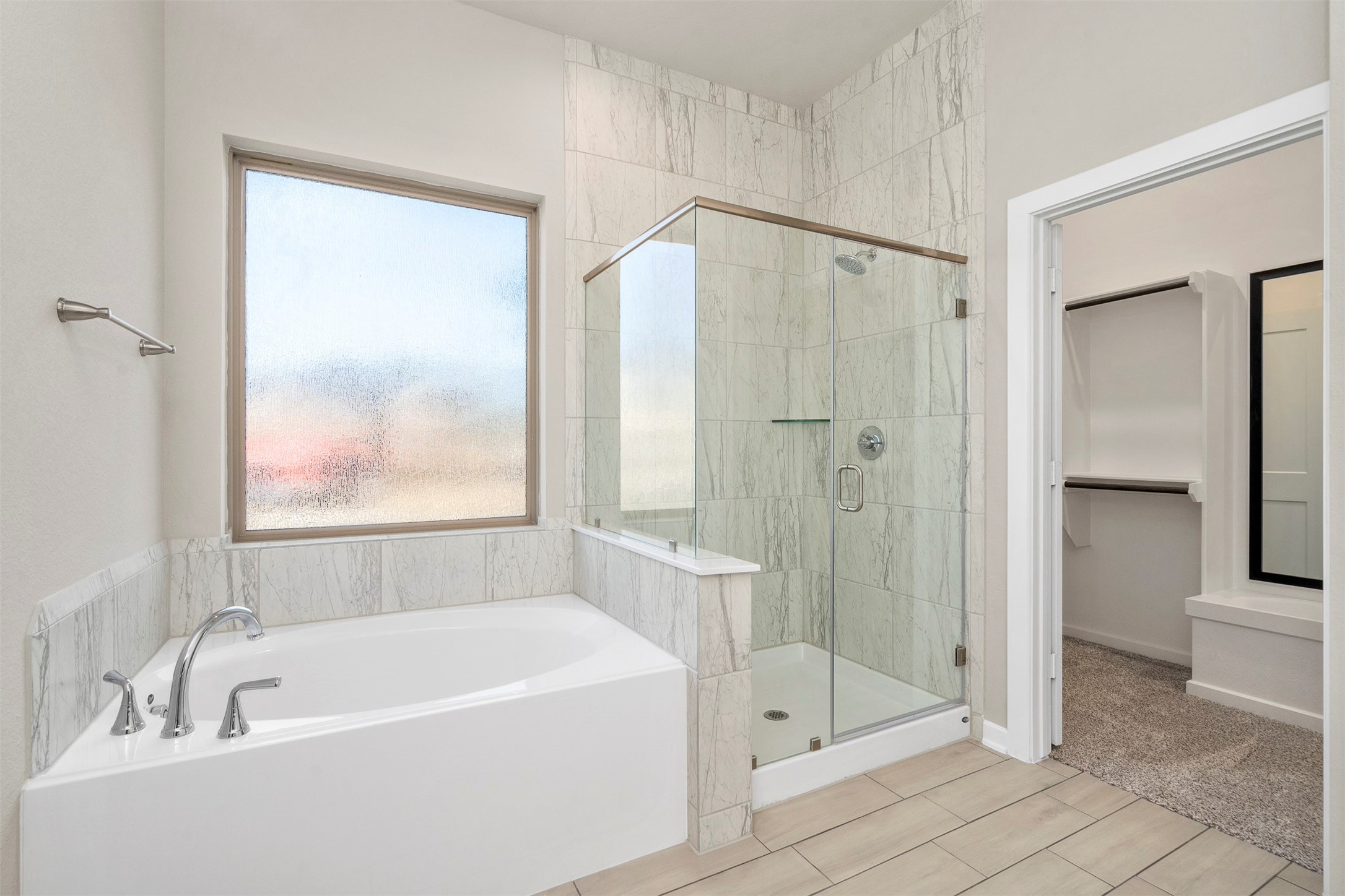 107 Yellow Perch Way Conroe, TX 77318 - Photo 22 of 36 a bathroom with a tub a mirror and a shower