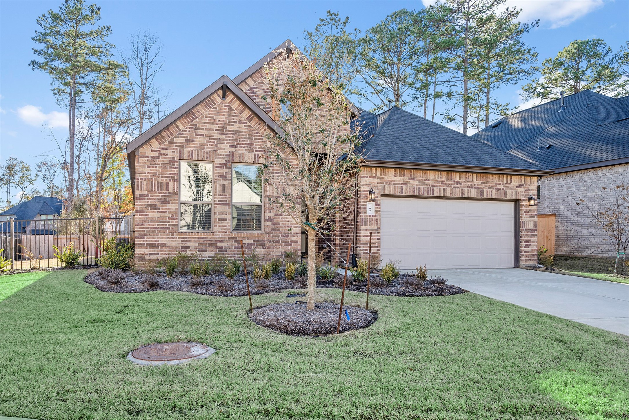 107 Yellow Perch Way Conroe, TX 77318 - Photo 3 of 36 a front view of a house with a yard