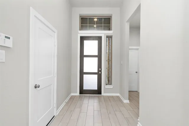 a large white kitchen with cabinets