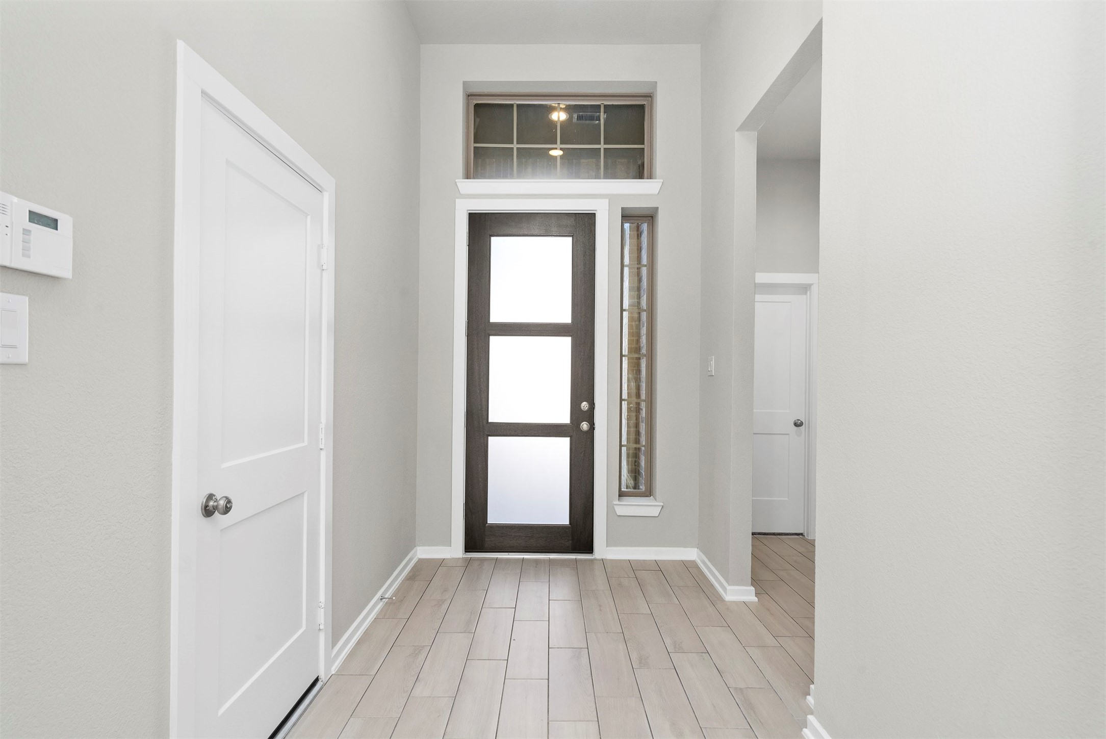 107 Yellow Perch Way Conroe, TX 77318 - Photo 6 of 36 a view of an empty room with wooden floor and a window