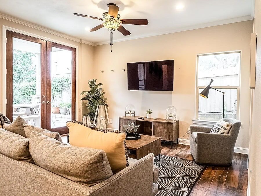 16308 Lake Loop Austin, TX 78734 - Photo 2 of 11 a living room with furniture a flat screen tv and a large window