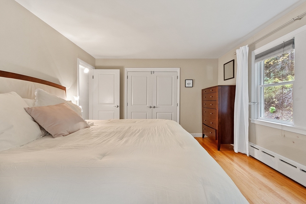 47 Summer Hill Road Maynard, MA 01754 - Photo 15 of 42 a bed room with a bed and a large mirror
