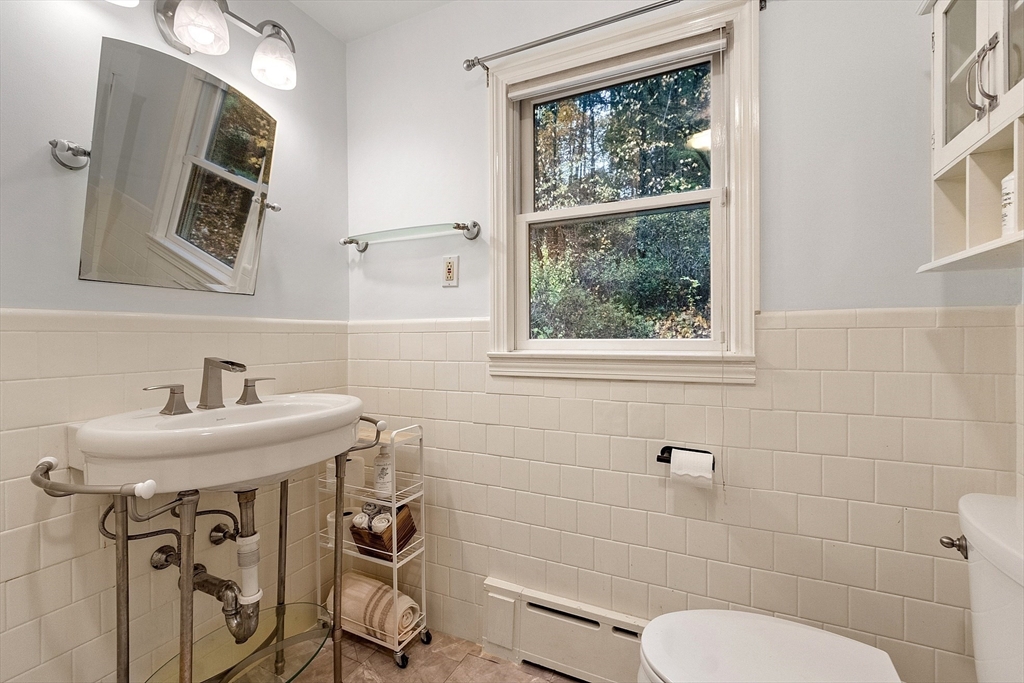 47 Summer Hill Road Maynard, MA 01754 - Photo 19 of 42 a bathroom with a sink a toilet and a mirror