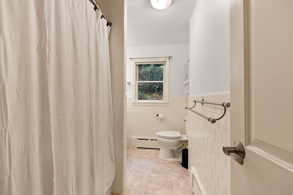 47 Summer Hill Road Maynard, MA 01754 - Photo 20 of 42 a bathroom with a toilet and a shower curtain