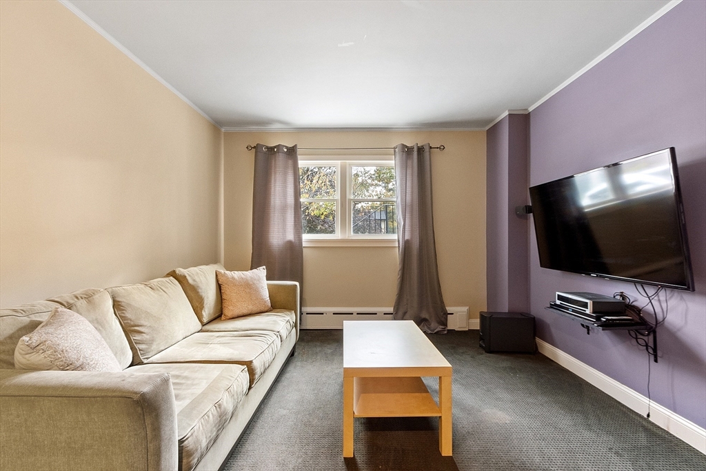 47 Summer Hill Road Maynard, MA 01754 - Photo 27 of 42 a living room with furniture and a flat screen tv