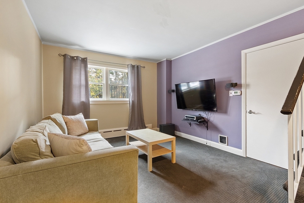 47 Summer Hill Road Maynard, MA 01754 - Photo 28 of 42 a living room with furniture and a flat screen tv