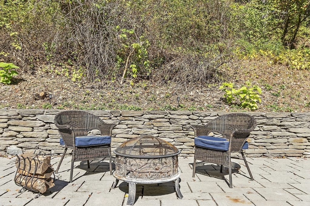 47 Summer Hill Road Maynard, MA 01754 - Photo 36 of 42 a view of a chairs and table in backyard