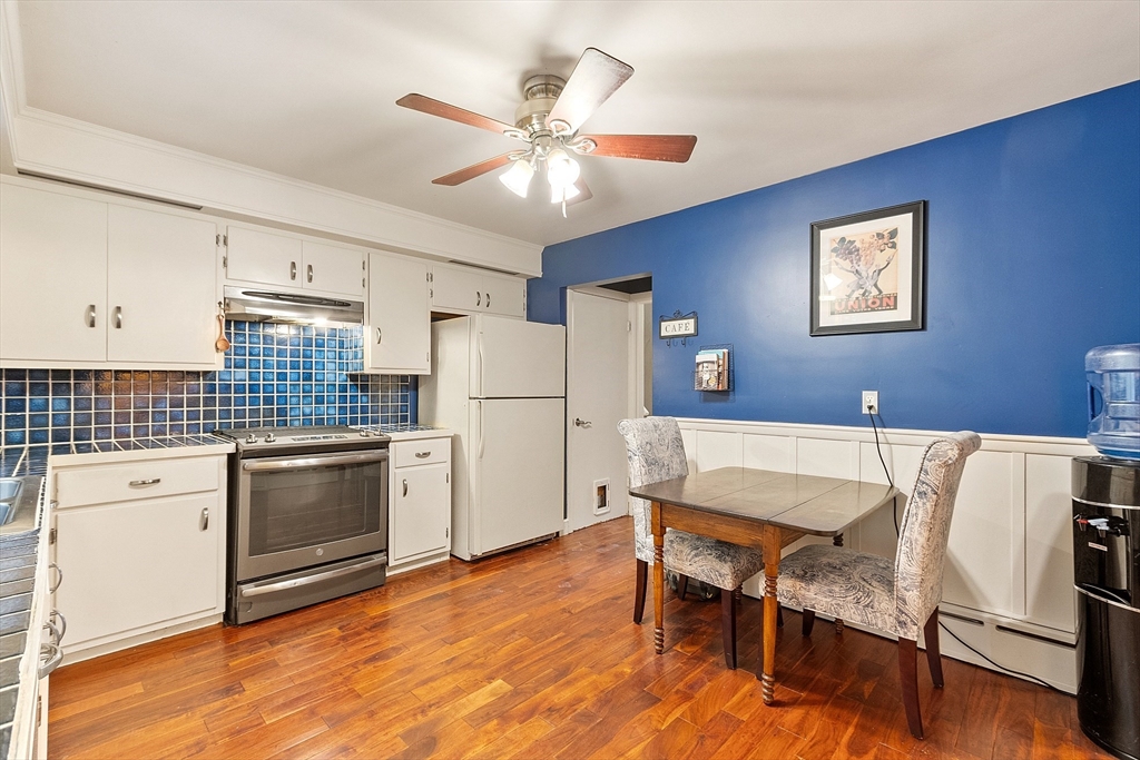 47 Summer Hill Road Maynard, MA 01754 - Photo 9 of 42 a kitchen with stainless steel appliances wooden floor and white cabinets