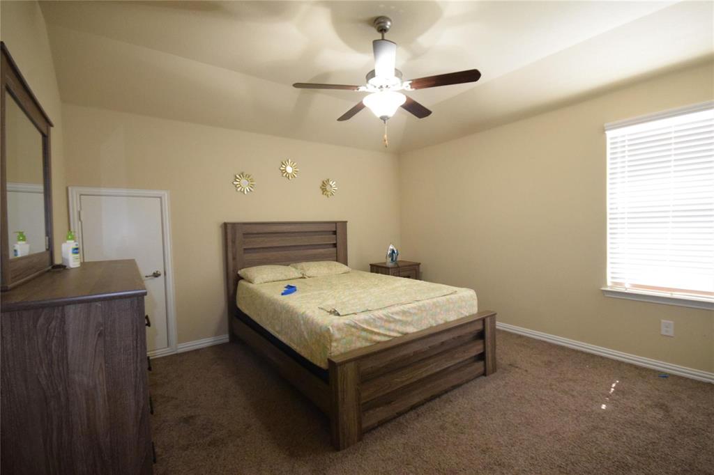 12421 Hitch Rack Way McKinney, TX 75071 - Photo 13 of 21 a spacious bedroom with a bed and a dresser