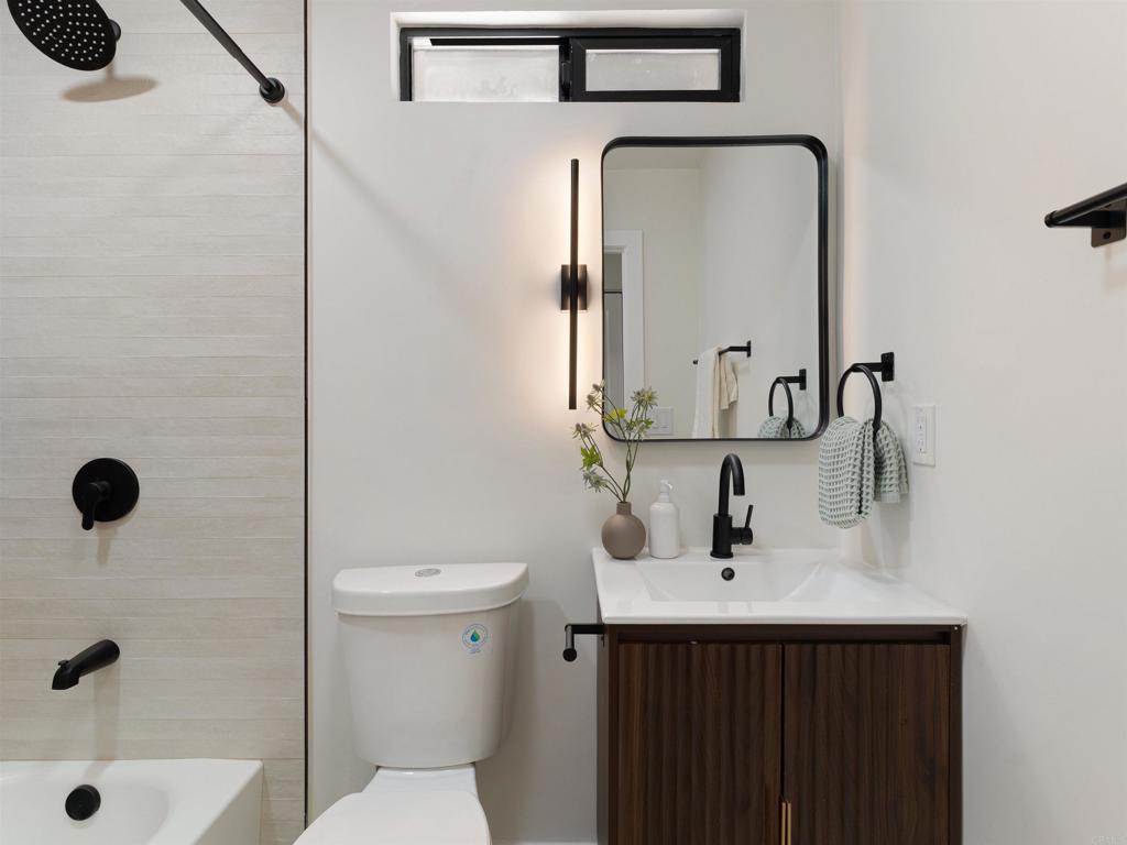 1482 Avocado Road Oceanside, CA 92054 - Photo 14 of 35 a bathroom with a sink a toilet and shower