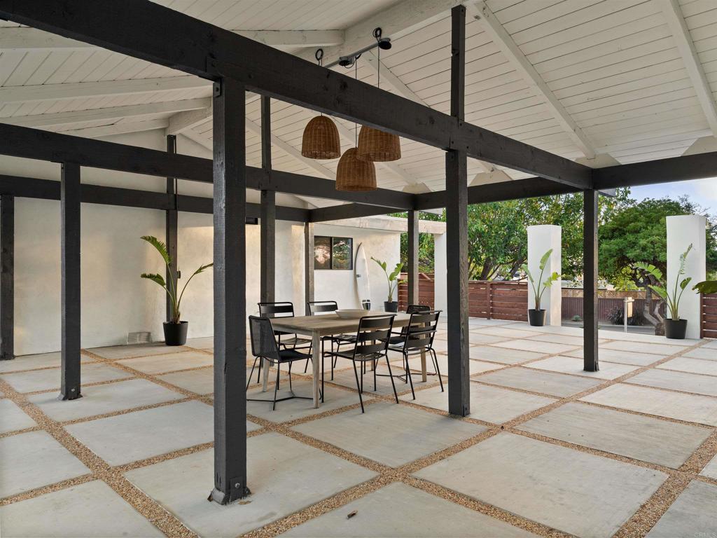 1482 Avocado Road Oceanside, CA 92054 - Photo 16 of 35 a view of a patio with table and chairs potted plants with floor to ceiling window