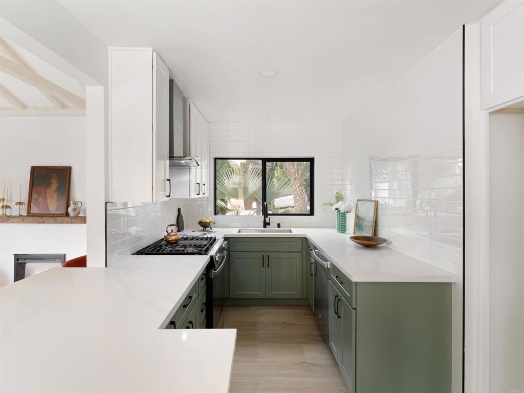 1482 Avocado Road Oceanside, CA 92054 - Photo 18 of 35 a kitchen with a sink a stove and cabinets