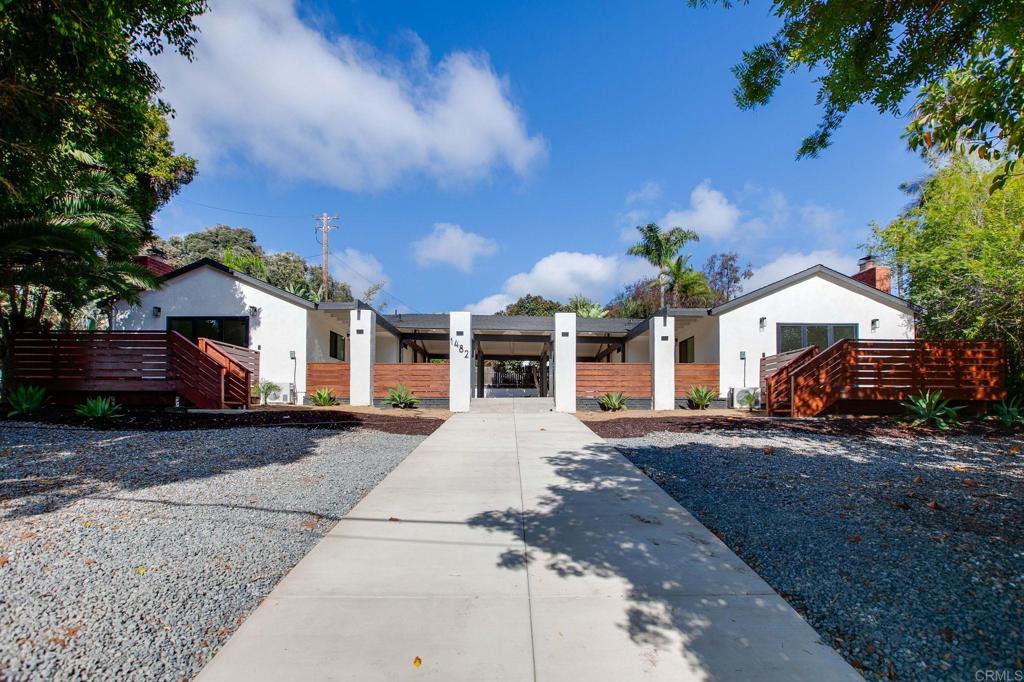 1482 Avocado Road Oceanside, CA 92054 - Photo 2 of 35 a front view of a house with a yard and garage