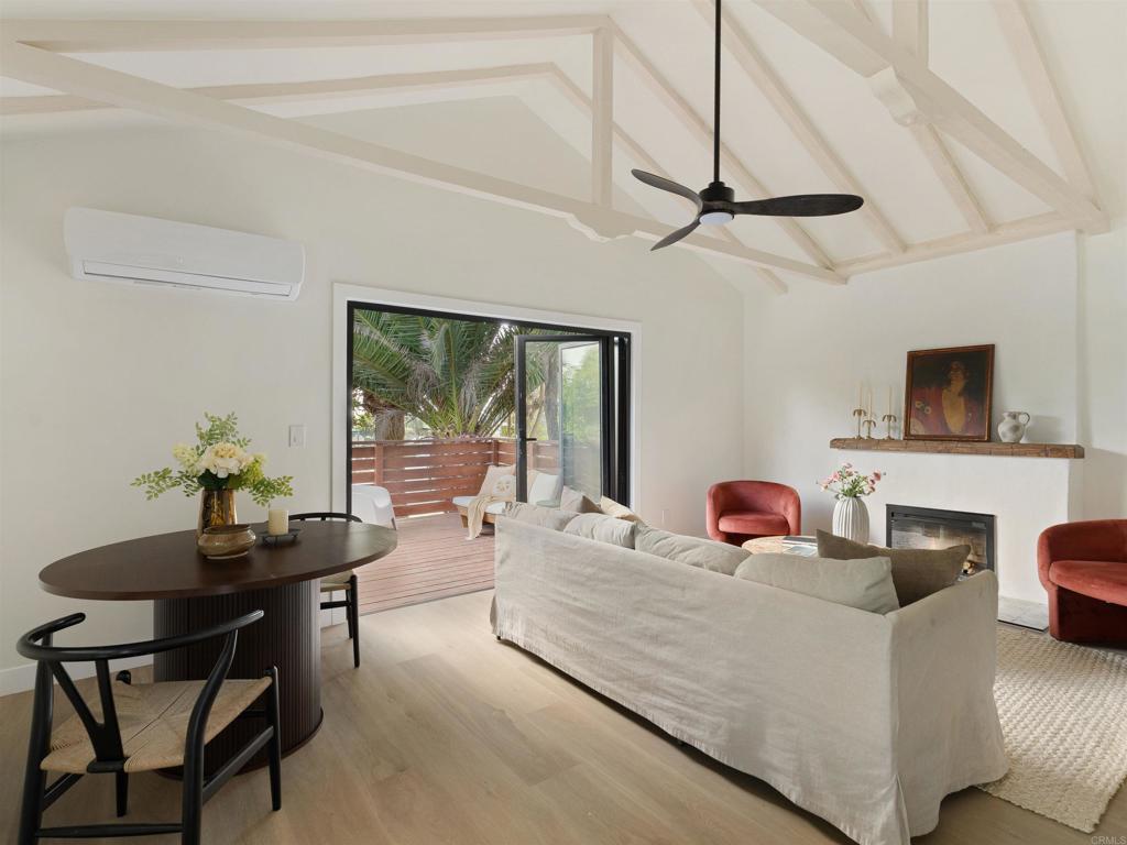 1482 Avocado Road Oceanside, CA 92054 - Photo 22 of 35 a living room with furniture a flat screen tv and a window