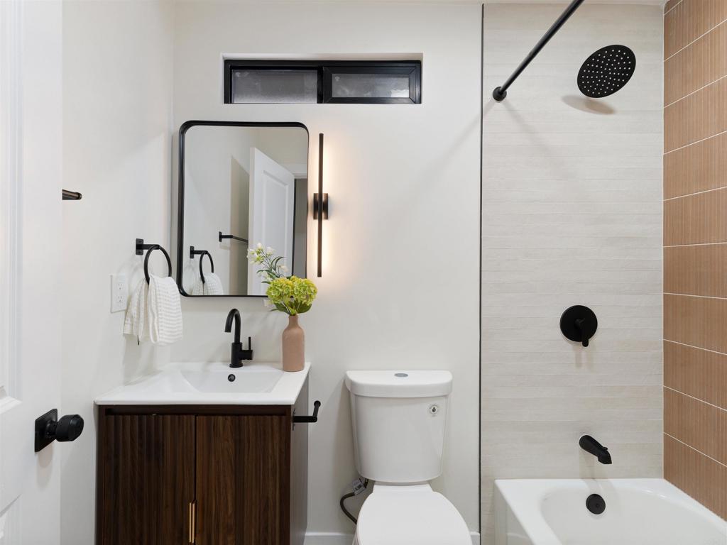 1482 Avocado Road Oceanside, CA 92054 - Photo 25 of 35 a bathroom with a sink a toilet and shower