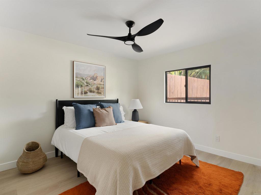 1482 Avocado Road Oceanside, CA 92054 - Photo 28 of 35 a bedroom with a bed and a painting on the wall