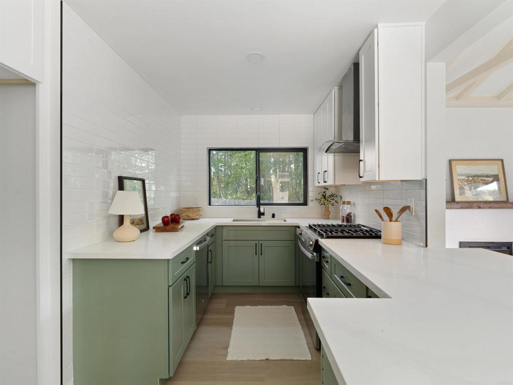 1482 Avocado Road Oceanside, CA 92054 - Photo 5 of 35 a kitchen with a sink stove and cabinets