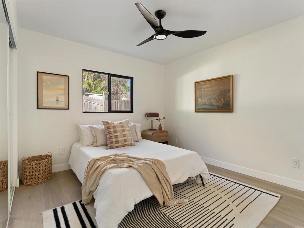 1482 Avocado Road Oceanside, CA 92054 - Photo 10 of 35 a bedroom with a bed and a painting on the wall