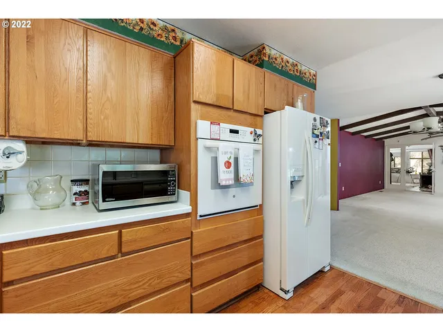 a kitchen with stainless steel appliances a refrigerator and a microwave