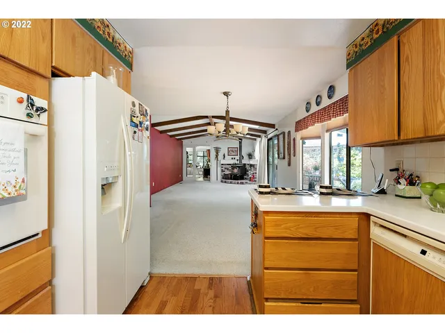 a kitchen view with granite countertop stainless steel appliances a stove a refrigerator and cabinets