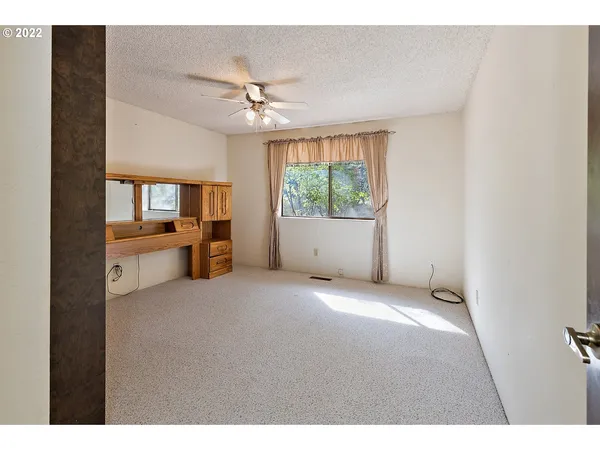 a view of a livingroom with furniture ceiling fan and window