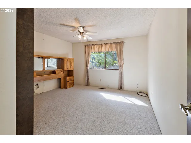 a view of a livingroom with furniture ceiling fan and window