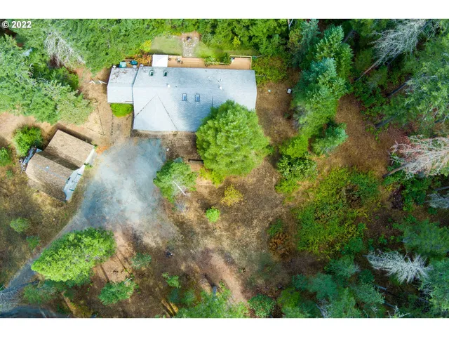an aerial view of a house with a yard basket ball court and outdoor seating